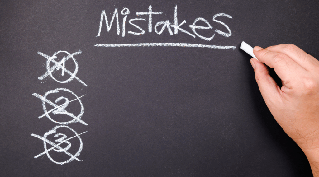 The word "mictakes" is written in white chalk on a gray blackboard