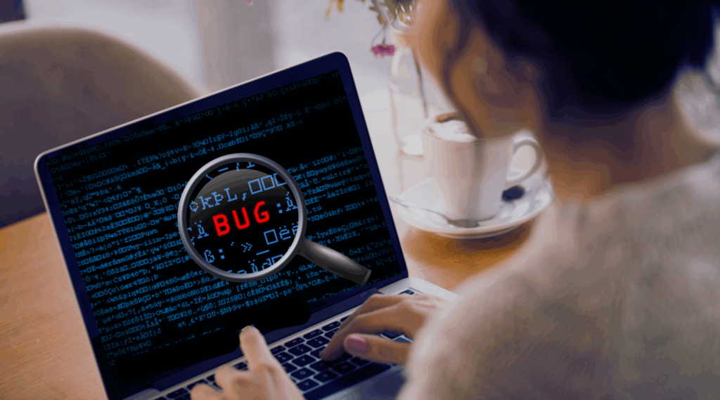 The word "bug" is displayed on the screen of a laptop on which a woman is working.