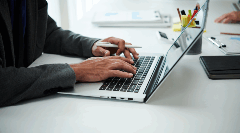 male hands typing on laptop keyboard