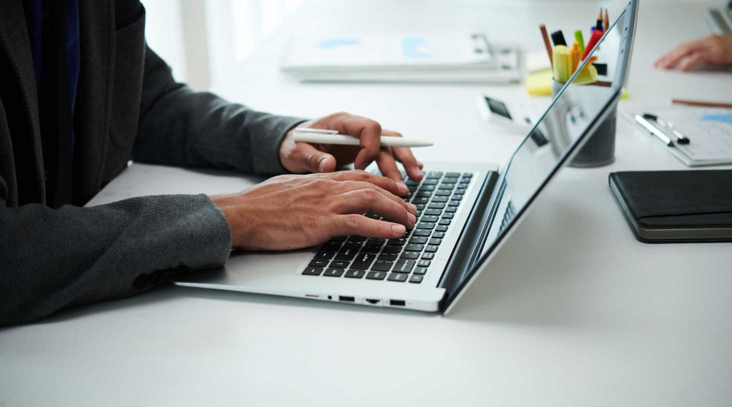 male hands typing on laptop keyboard