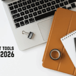 A laptop with a notebook and a tablet are lying on the table.