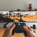 person hold black game controller