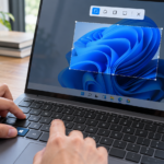 User pressing Win + Shift + S to open the Snipping Tool screenshot overlay on a Windows 11 laptop.